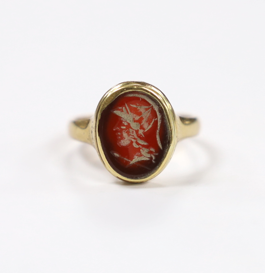 An antique 9ct and intaglio glass? set oval ring, depicting the bust of a Roman soldier to dexter, size P, gross weight 3.8 grams.